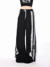 Black track pants with white lace trim and stripes